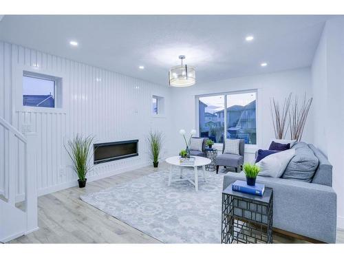 122 Saddlecrest Landing Ne, Calgary, AB - Indoor Photo Showing Living Room With Fireplace