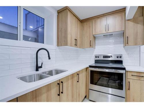 122 Saddlecrest Landing Ne, Calgary, AB - Indoor Photo Showing Kitchen With Double Sink With Upgraded Kitchen