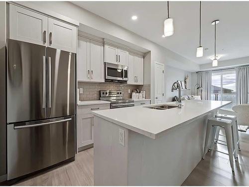 318-4350 Seton Drive Se, Calgary, AB - Indoor Photo Showing Kitchen With Stainless Steel Kitchen With Double Sink With Upgraded Kitchen