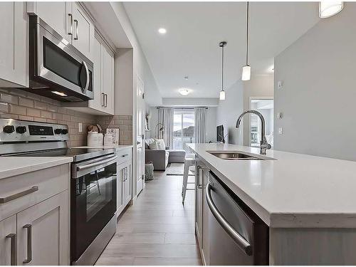 318-4350 Seton Drive Se, Calgary, AB - Indoor Photo Showing Kitchen With Stainless Steel Kitchen With Double Sink With Upgraded Kitchen