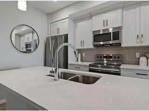 318-4350 Seton Drive Se, Calgary, AB - Indoor Photo Showing Kitchen With Stainless Steel Kitchen With Double Sink With Upgraded Kitchen