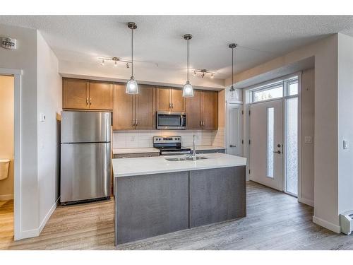 12-30 Shawnee Common Sw, Calgary, AB - Indoor Photo Showing Kitchen With Stainless Steel Kitchen With Double Sink