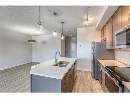 12-30 Shawnee Common Sw, Calgary, AB - Indoor Photo Showing Kitchen With Stainless Steel Kitchen With Double Sink With Upgraded Kitchen