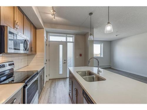 12-30 Shawnee Common Sw, Calgary, AB - Indoor Photo Showing Kitchen With Stainless Steel Kitchen With Double Sink With Upgraded Kitchen