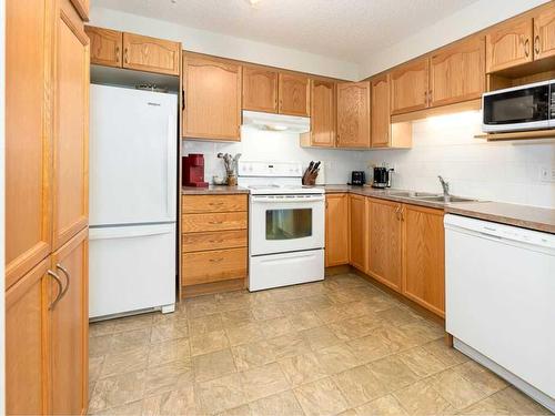 1111-200 Community, Okotoks, AB - Indoor Photo Showing Kitchen With Double Sink