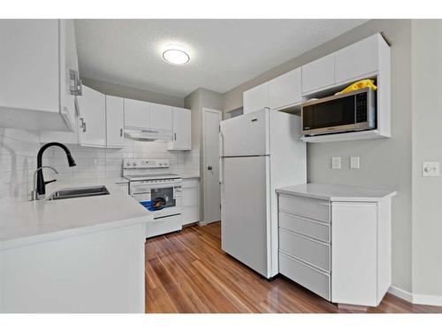 29 Sandpiper Link Nw, Calgary, AB - Indoor Photo Showing Kitchen With Double Sink