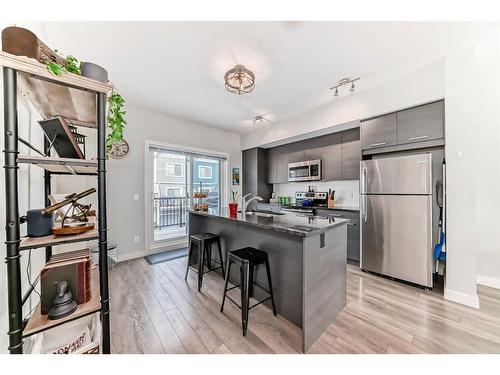 2406 Jumping Pound Common, Cochrane, AB - Indoor Photo Showing Kitchen With Stainless Steel Kitchen