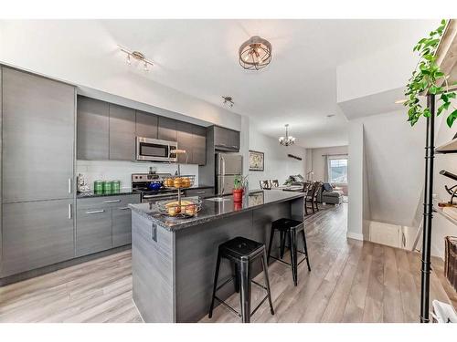 2406 Jumping Pound Common, Cochrane, AB - Indoor Photo Showing Kitchen With Stainless Steel Kitchen With Upgraded Kitchen