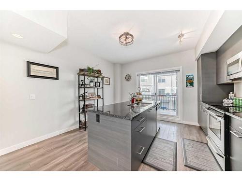 2406 Jumping Pound Common, Cochrane, AB - Indoor Photo Showing Kitchen With Upgraded Kitchen