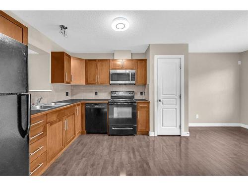 113 Panatella Road Nw, Calgary, AB - Indoor Photo Showing Kitchen With Double Sink