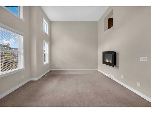 113 Panatella Road Nw, Calgary, AB - Indoor Photo Showing Other Room With Fireplace