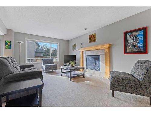 229 Cougar Ridge Drive Sw, Calgary, AB - Indoor Photo Showing Living Room With Fireplace