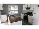 214 8 Street, Beiseker, AB  - Indoor Photo Showing Kitchen With Double Sink 