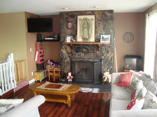 512 School Road, Trochu, AB - Indoor Photo Showing Living Room With Fireplace