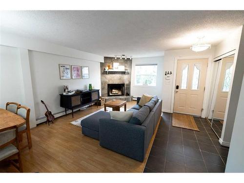 3-713 Mcdougall Road Ne, Calgary, AB - Indoor Photo Showing Living Room With Fireplace