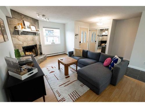 3-713 Mcdougall Road Ne, Calgary, AB - Indoor Photo Showing Living Room With Fireplace