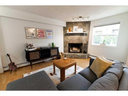 3-713 Mcdougall Road Ne, Calgary, AB - Indoor Photo Showing Living Room With Fireplace