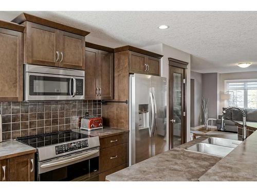 2486 Ravenswood View Se, Airdrie, AB - Indoor Photo Showing Kitchen With Double Sink With Upgraded Kitchen