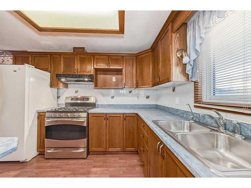 231 Shawglen Road Sw, Calgary, AB - Indoor Photo Showing Kitchen With Double Sink