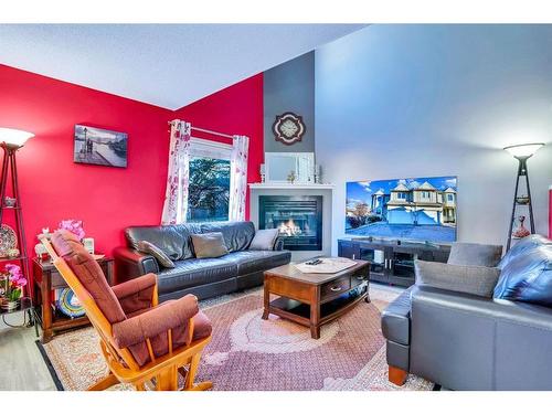 2-468 Woodbine Boulevard Sw, Calgary, AB - Indoor Photo Showing Living Room With Fireplace