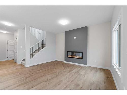 23 Key Cove, Airdrie, AB - Indoor Photo Showing Other Room With Fireplace