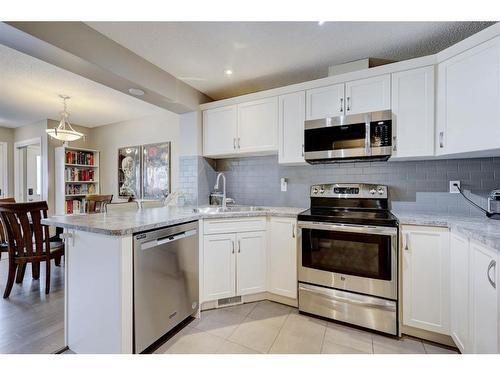 1587 Windstone Road Sw, Airdrie, AB - Indoor Photo Showing Kitchen With Stainless Steel Kitchen With Upgraded Kitchen