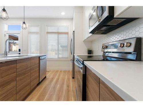 117 Heartland Street, Cochrane, AB - Indoor Photo Showing Kitchen With Stainless Steel Kitchen With Upgraded Kitchen