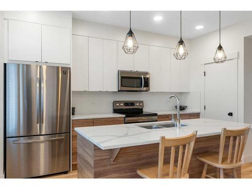 117 Heartland Street, Cochrane, AB - Indoor Photo Showing Kitchen With Stainless Steel Kitchen With Double Sink With Upgraded Kitchen