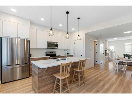 117 Heartland Street, Cochrane, AB - Indoor Photo Showing Kitchen With Stainless Steel Kitchen With Double Sink With Upgraded Kitchen