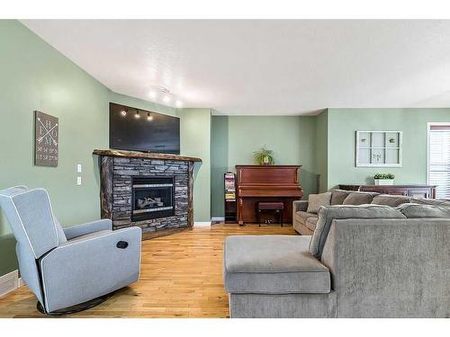 35 Elgin Green Se, Calgary, AB - Indoor Photo Showing Living Room With Fireplace