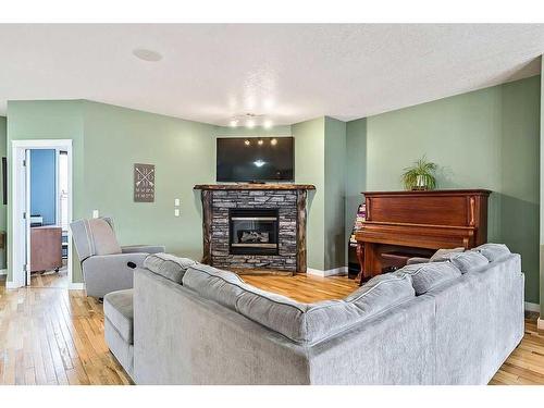 35 Elgin Green Se, Calgary, AB - Indoor Photo Showing Living Room With Fireplace