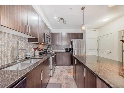 304-23 Millrise Drive Sw, Calgary, AB - Indoor Photo Showing Kitchen With Stainless Steel Kitchen With Double Sink With Upgraded Kitchen