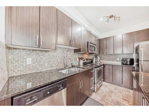 304-23 Millrise Drive Sw, Calgary, AB - Indoor Photo Showing Kitchen With Stainless Steel Kitchen With Double Sink With Upgraded Kitchen