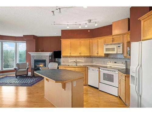 401-4 14 Street Nw, Calgary, AB - Indoor Photo Showing Kitchen With Fireplace With Double Sink