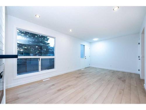 19-11407 Braniff Road Sw, Calgary, AB - Indoor Photo Showing Living Room With Fireplace