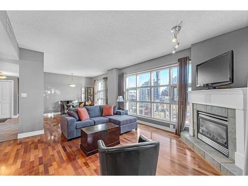 704-110 7 Street Sw, Calgary, AB - Indoor Photo Showing Living Room With Fireplace