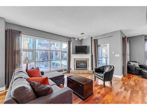 704-110 7 Street Sw, Calgary, AB - Indoor Photo Showing Living Room With Fireplace