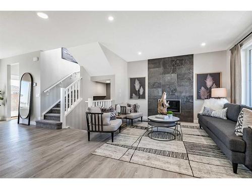 264 Northern Lights Crescent, Langdon, AB - Indoor Photo Showing Living Room With Fireplace