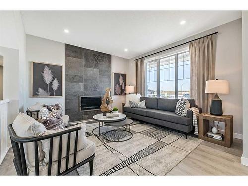 264 Northern Lights Crescent, Langdon, AB - Indoor Photo Showing Living Room With Fireplace