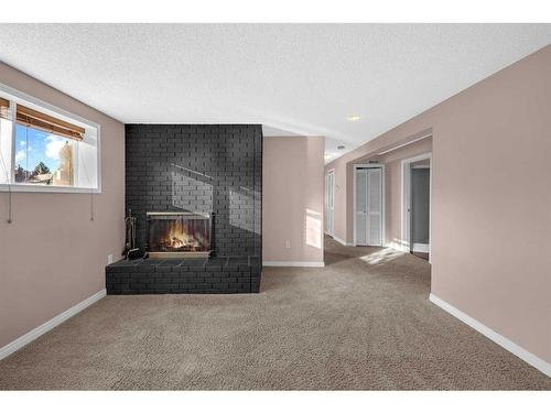 5007 Vantage Crescent Nw, Calgary, AB - Indoor Photo Showing Living Room With Fireplace