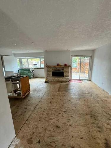 240 Lake Bonavista Drive Se, Calgary, AB - Indoor Photo Showing Living Room With Fireplace