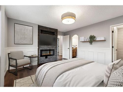 254 Auburn Bay Boulevard Se, Calgary, AB - Indoor Photo Showing Bedroom With Fireplace