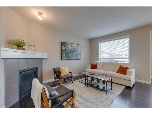 1170 Kings Heights Way Se, Airdrie, AB - Indoor Photo Showing Living Room With Fireplace