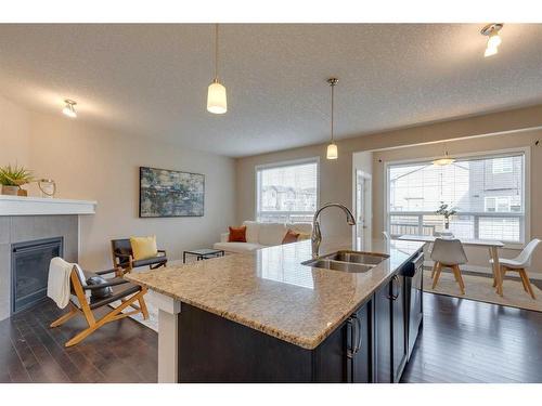 1170 Kings Heights Way Se, Airdrie, AB - Indoor Photo Showing Other Room With Fireplace