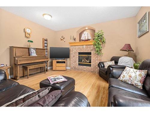 55 Chapman Way Se, Calgary, AB - Indoor Photo Showing Living Room With Fireplace