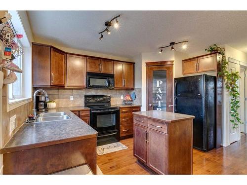 10 Silverado Plains Manor Sw, Calgary, AB - Indoor Photo Showing Kitchen With Double Sink