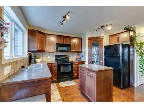 10 Silverado Plains Manor Sw, Calgary, AB - Indoor Photo Showing Kitchen With Double Sink