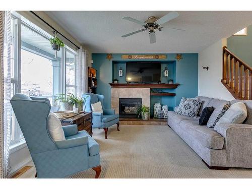 10 Silverado Plains Manor Sw, Calgary, AB - Indoor Photo Showing Living Room With Fireplace