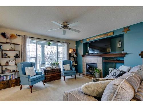 10 Silverado Plains Manor Sw, Calgary, AB - Indoor Photo Showing Living Room With Fireplace