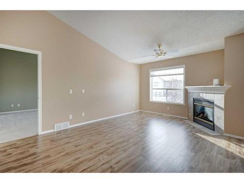 126 Mt Douglas Villas Se, Calgary, AB - Indoor Photo Showing Living Room With Fireplace